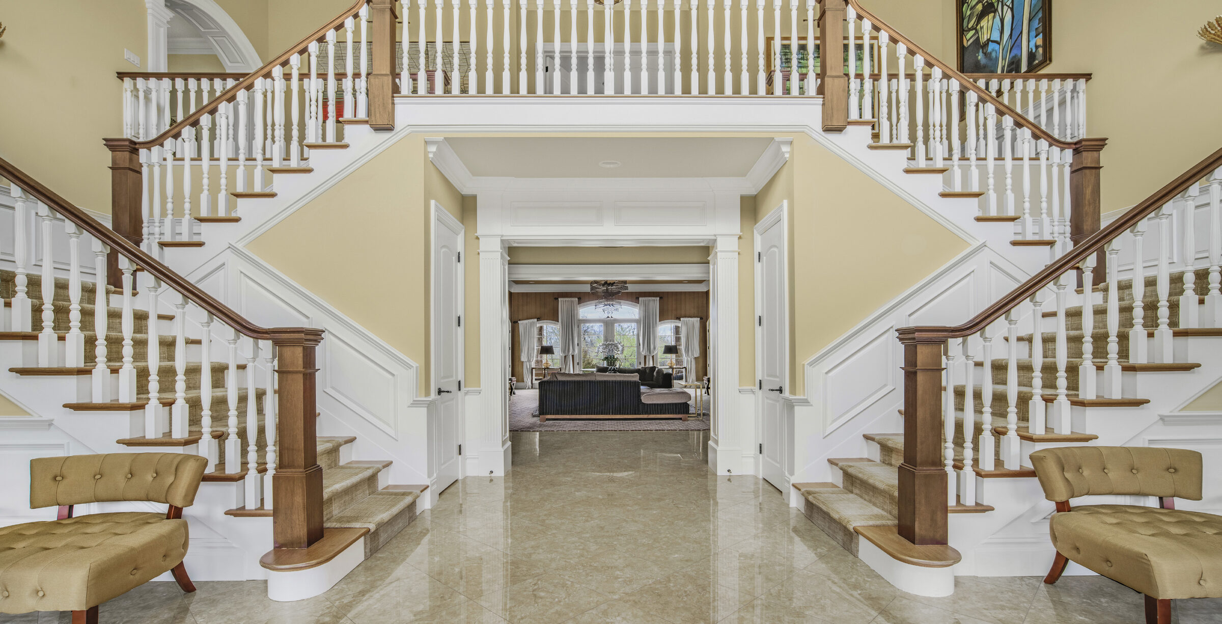 double-height foyer with twin curved staircases at The Princeton Preserve