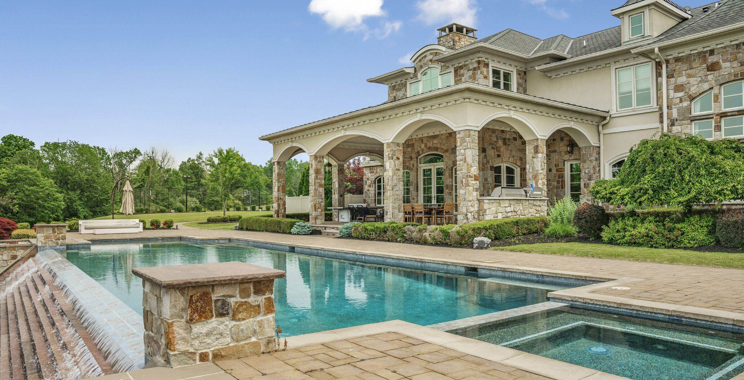heated in-ground pool and stone terraces at the rear of The Princeton Preserve